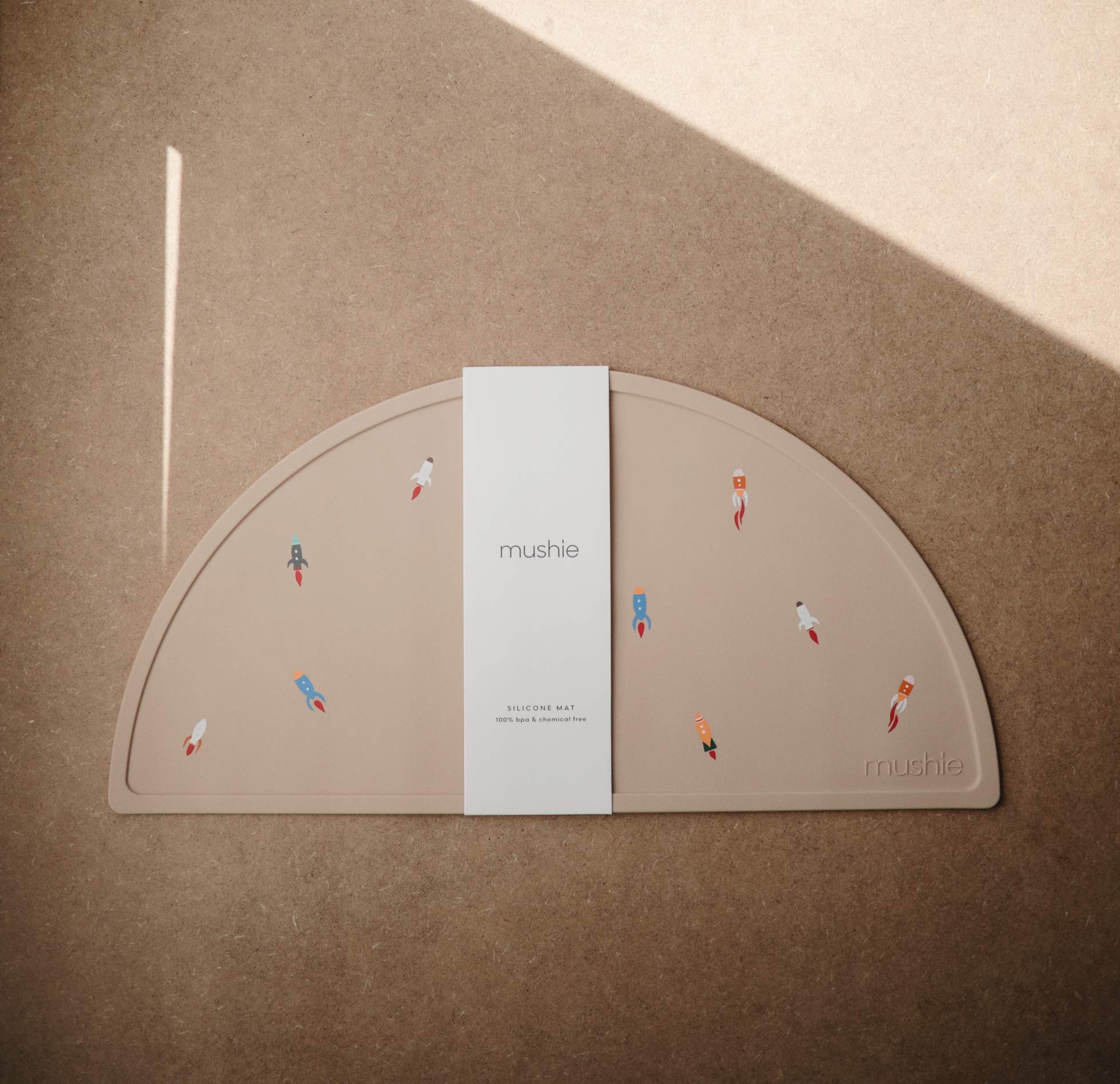 Mushie silicone placemat non-slip base stays put on highchair trays during meals