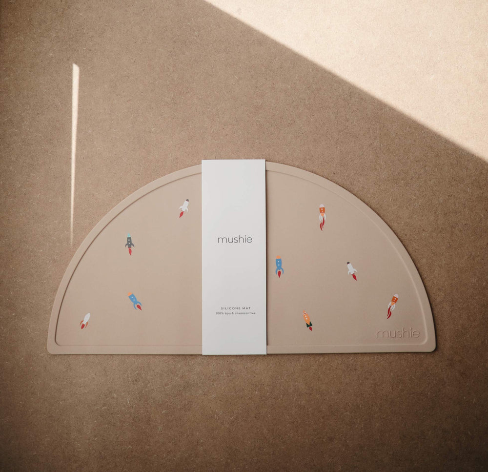 Mushie silicone placemat non-slip base stays put on highchair trays during meals