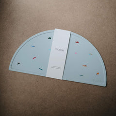 Mushie silicone placemat with non-slip bottom stabilizes bowls during mealtime