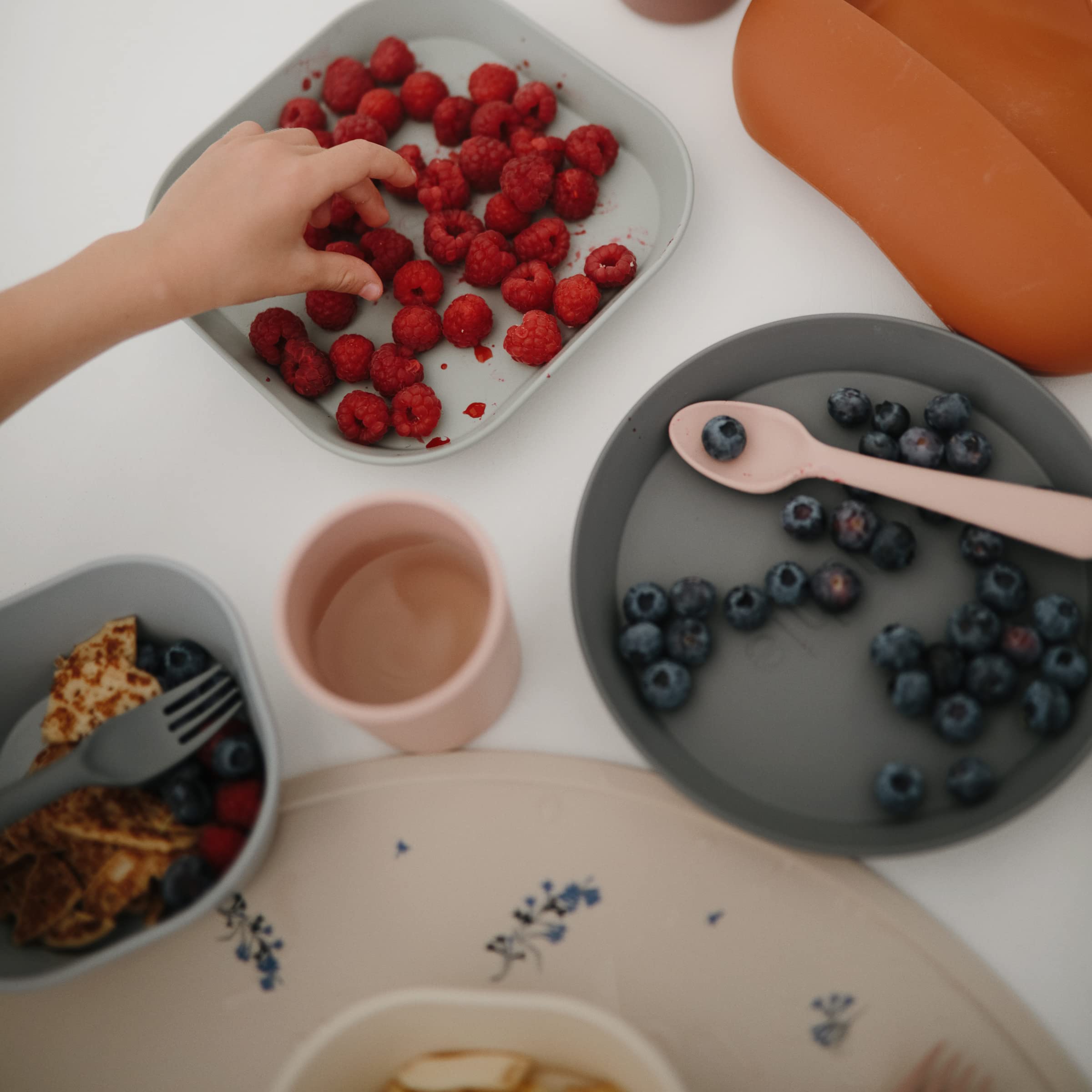 Mushie silicone placemat Lilac Flowers stain-resistant surface resists spills.