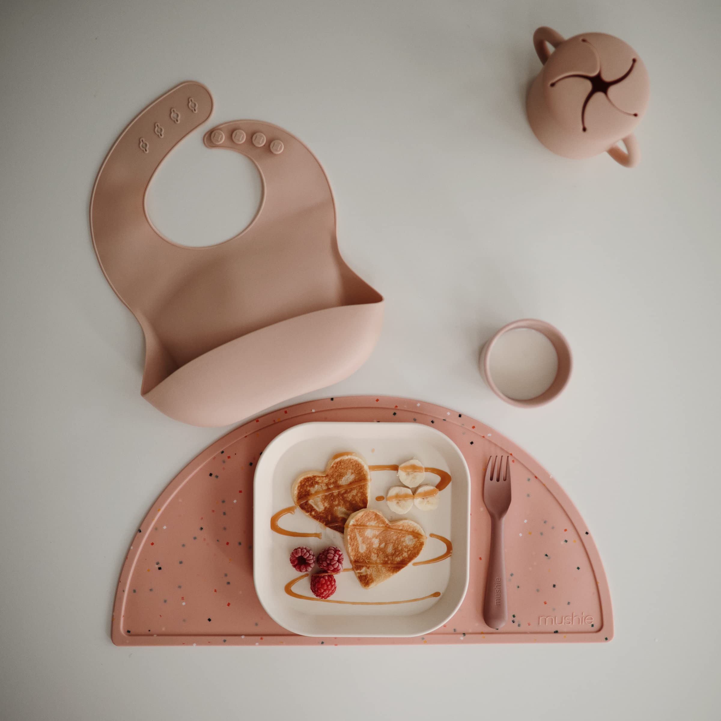 Mushie silicone placemat non-slip bottom keeps kid's plate in place during meals.
