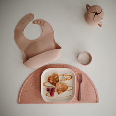 Mushie silicone placemat non-slip bottom keeps kid's plate in place during meals.
