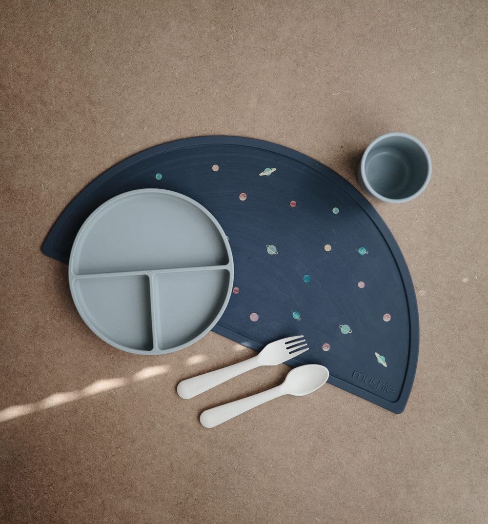Mushie silicone placemat planets closeup texture highlights soft flexible surface for mess-free meals