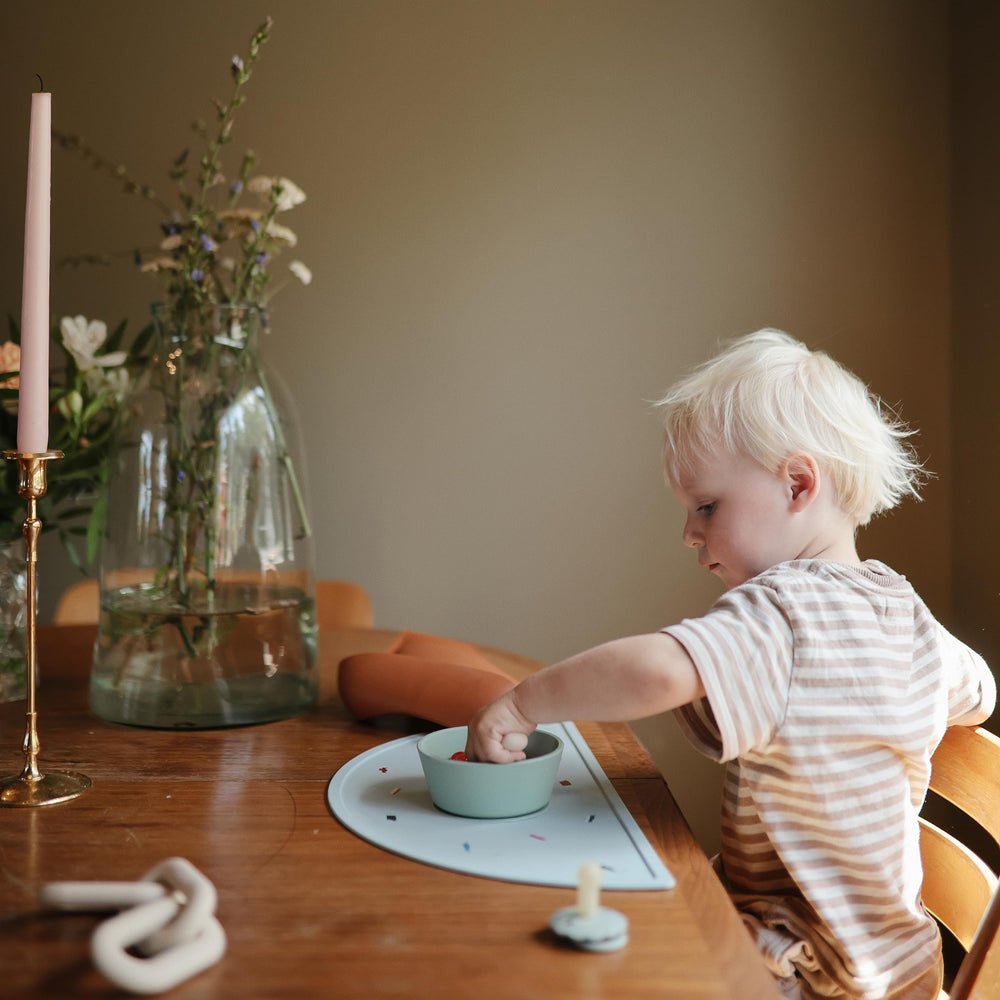 Mushie silicone placemat planets dishwasher-safe design simplifies after-meal cleanup