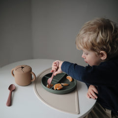 Mushie silicone placemat safety image highlights BPA-free materials.