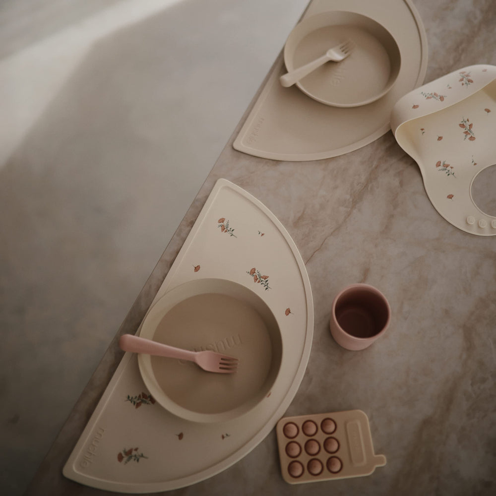 Mushie silicone placemat Shifting Sand stackable-design highlights compact storage and quick setup.