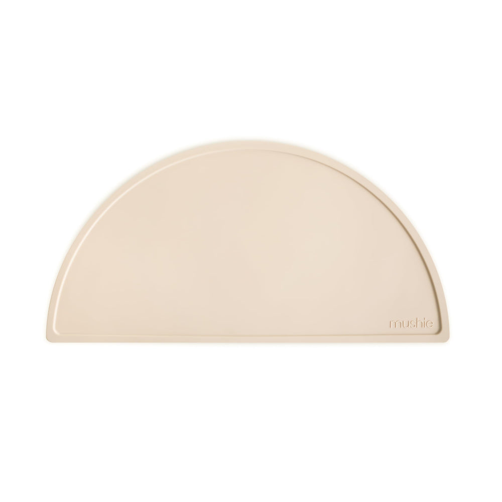 Mushie silicone placemat Shifting Sand tabletop hero shows non-slip base for tidy mealtimes.