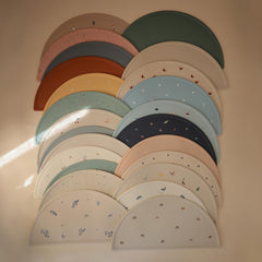 Mushie silicone placemat close-up shows soft, BPA-free material for gentle feeding.