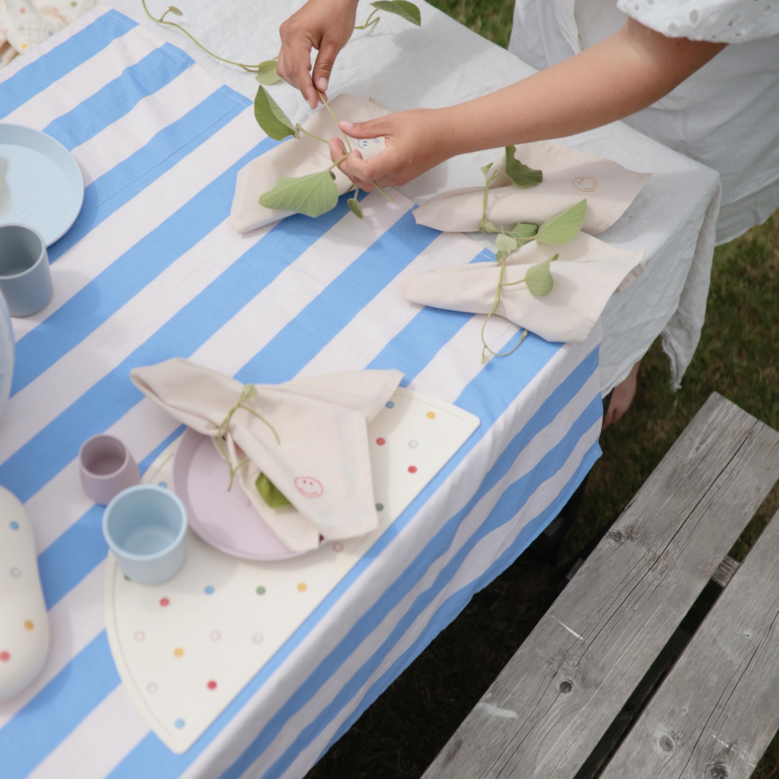 Mushie silicone placemat stain-resistant surface stays bright during family meals.