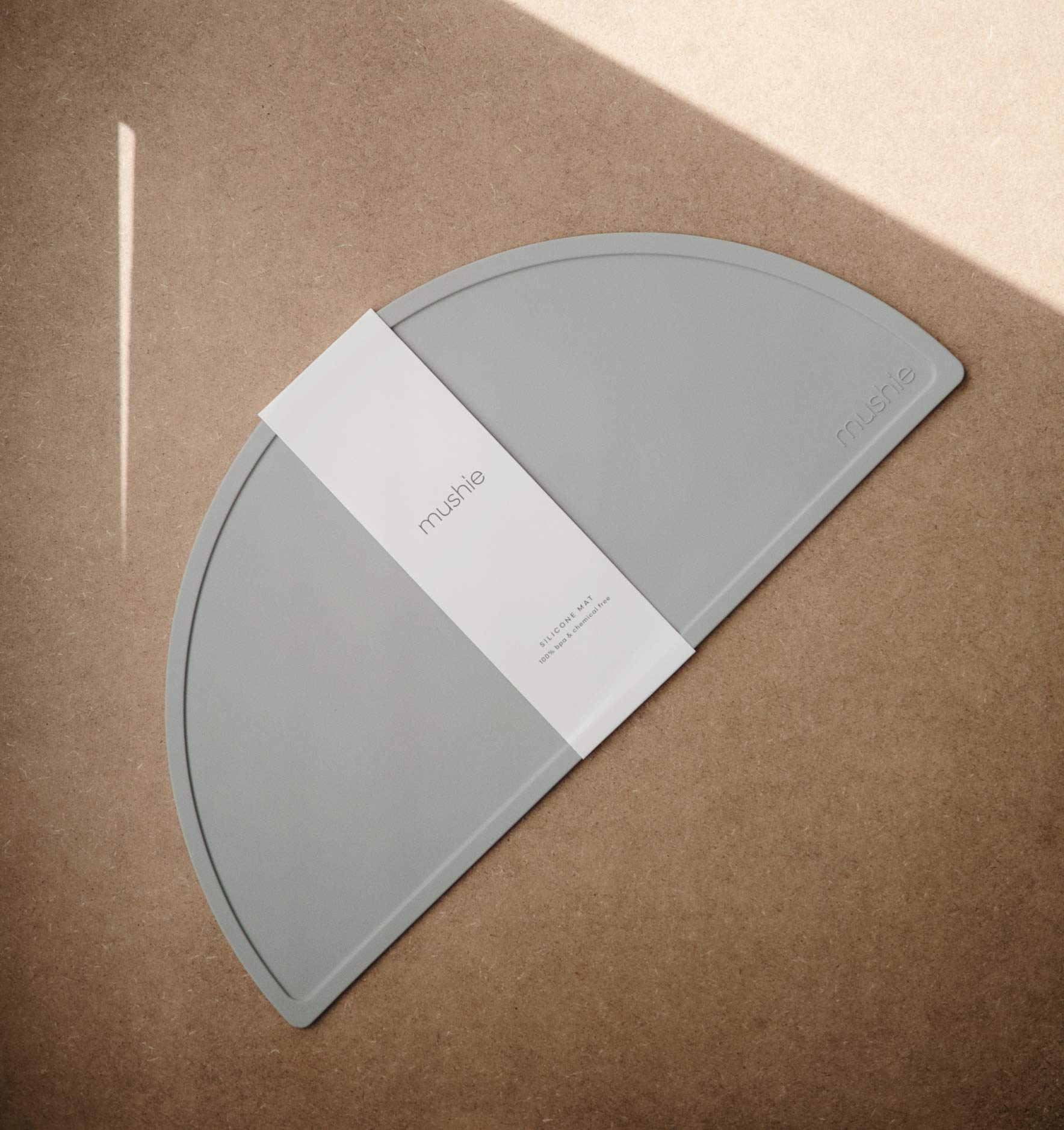 Mushie silicone placemat stone closeup texture reveals smooth, BPA-free silicone safe for dining.