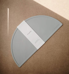 Mushie silicone placemat stone closeup texture reveals smooth, BPA-free silicone safe for dining.