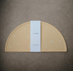 Mushie placemat edge close-up showing soft silicone edge