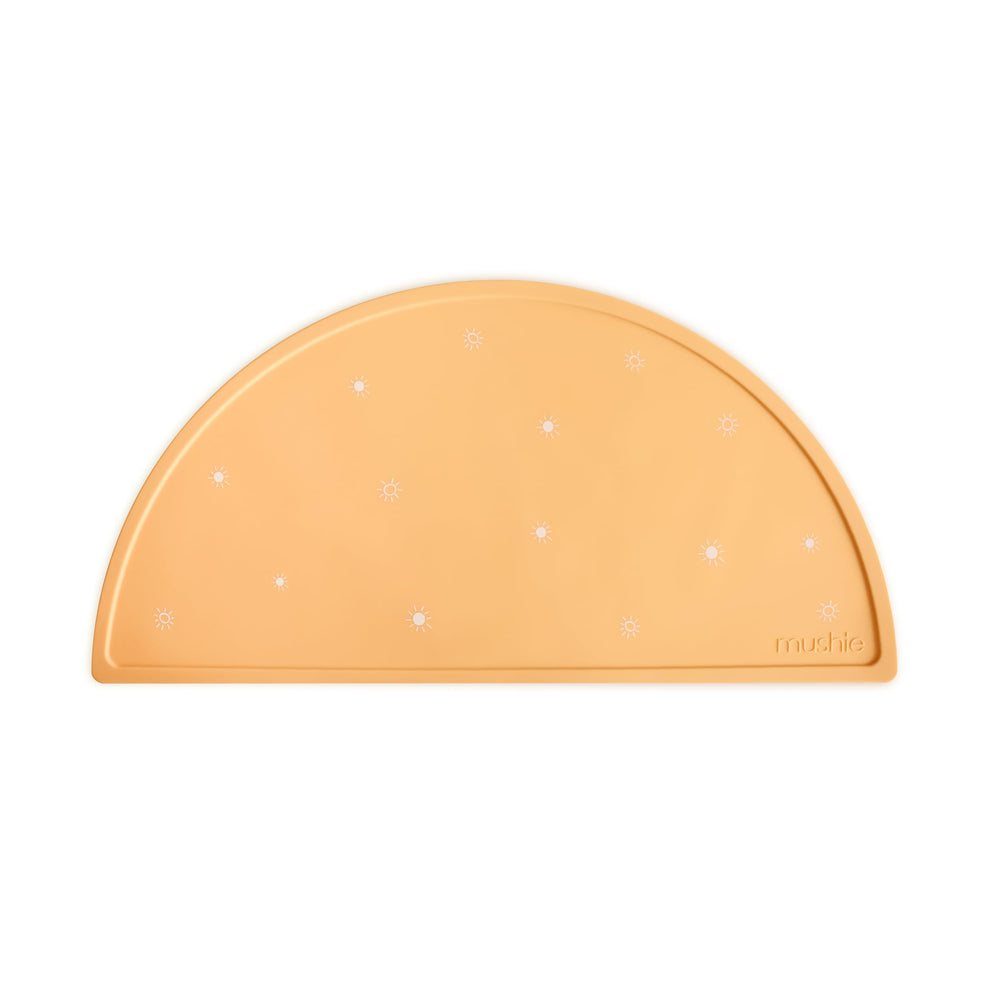 Mushie Sun Orange placemat on table for mess-free meals