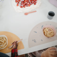 Mushie Sun Orange placemat demonstrates stain-resistant, wipe-clean surface