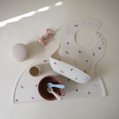 Mushie silicone placemat table-setup shows safe, non-slip dining surface.