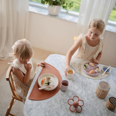 Mushie silicone plate close-up highlights 100% food-grade material and ivory finish.