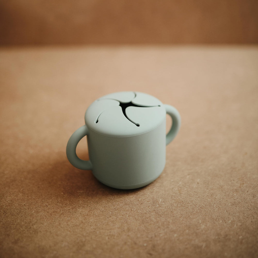 Mushie snack cup Cambridge Blue two handles aids tiny hands for secure self-feeding.