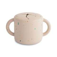 Mushie silicone snack cup close-up shows easy grip for little hands.