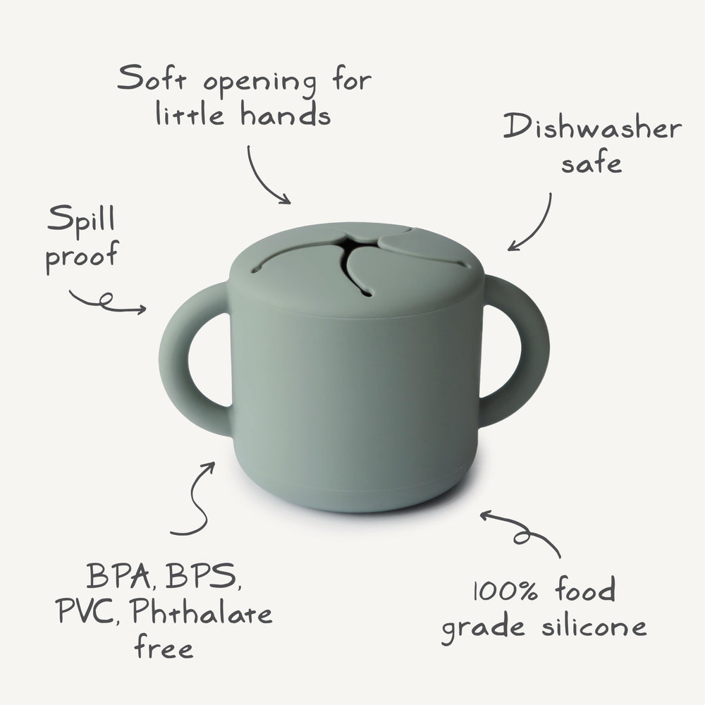 Mushie Silicone Snack Cup Ivory shows spill-proof base ideal for car trips.