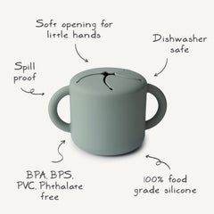 Mushie Silicone Snack Cup Ivory shows spill-proof base ideal for car trips.