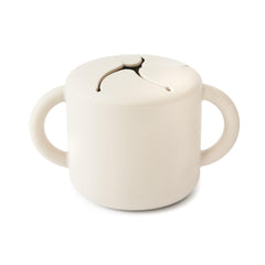 Mushie Silicone Snack Cup Ivory with two handles for easy toddler gripping during meals.
