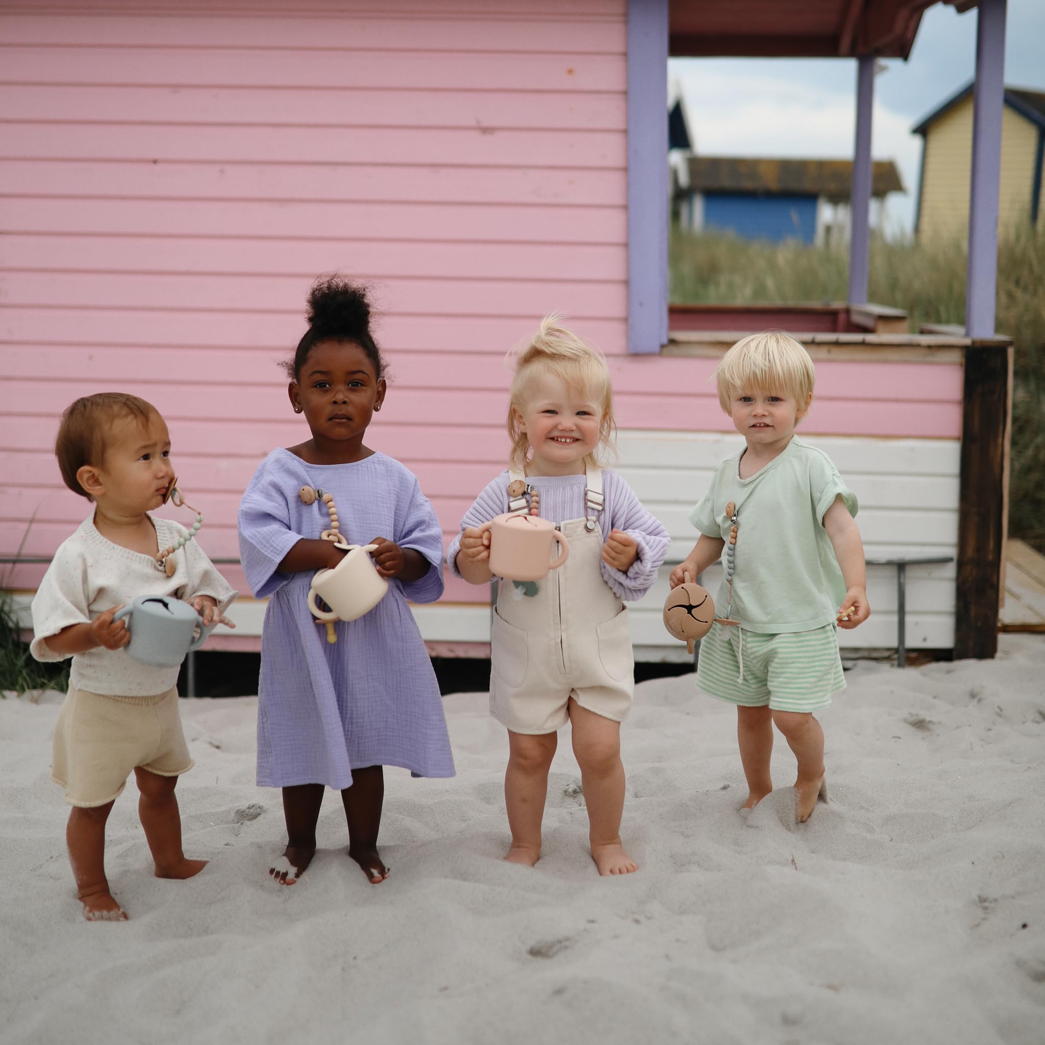 Mushie silicone snack cup on-the-go use for toddlers during outings.