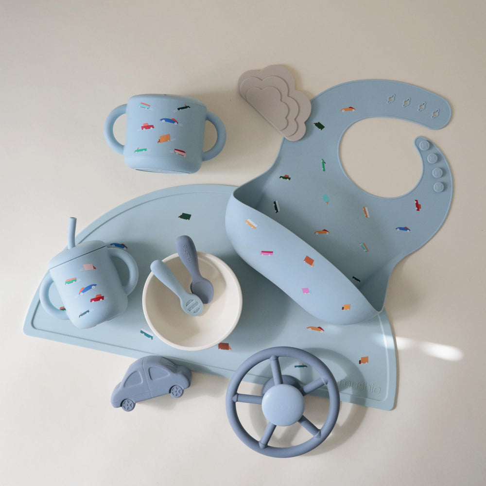 Mushie silicone snack cup soft opening for tiny hands during self-feeding.