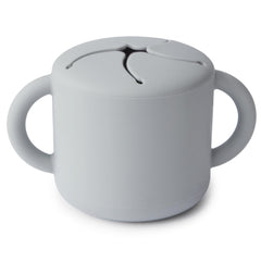 Mushie Silicone Snack Cup Stone side view highlights easy-grip dual handles for toddlers