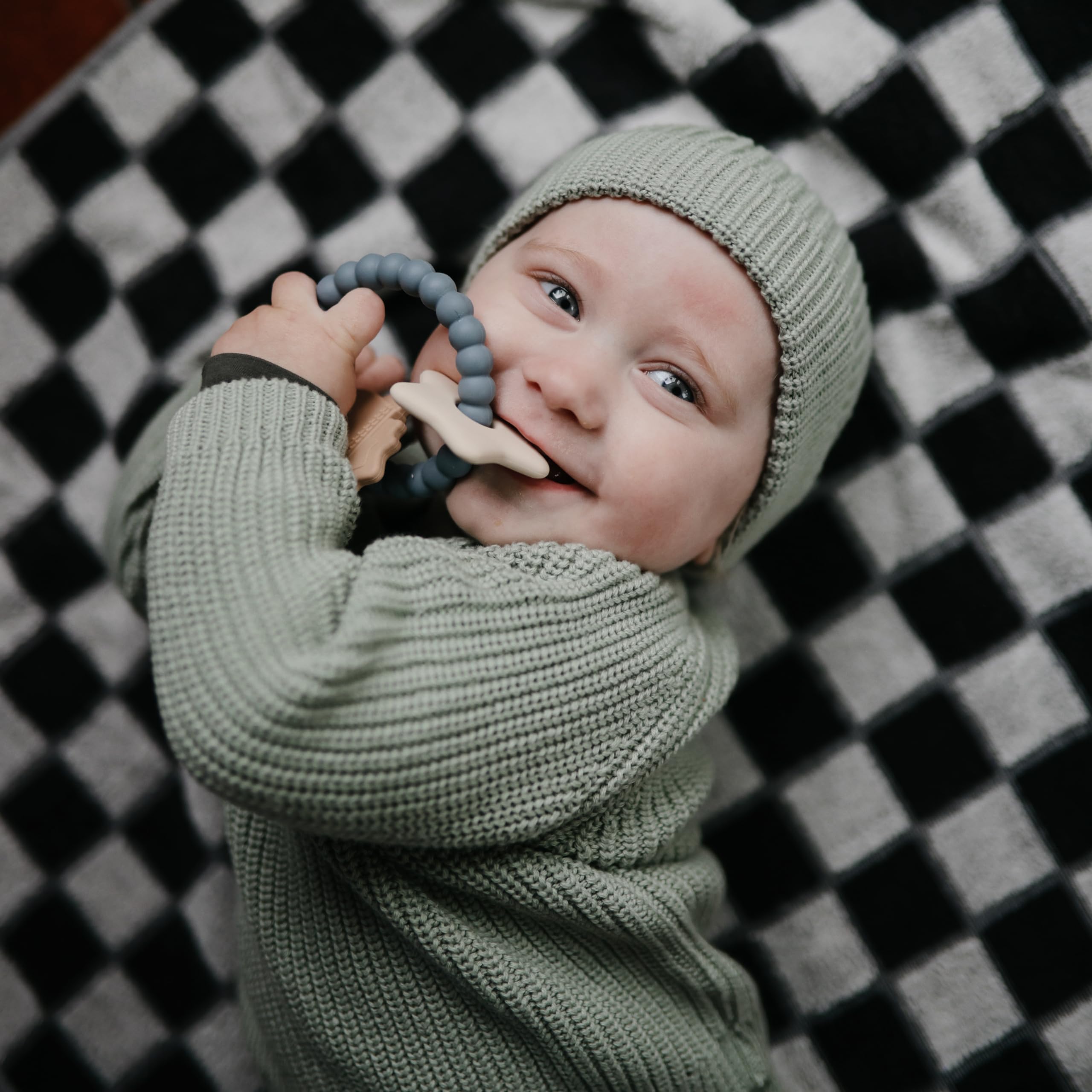Mushie space ring texture supports calm exploration during playtime.