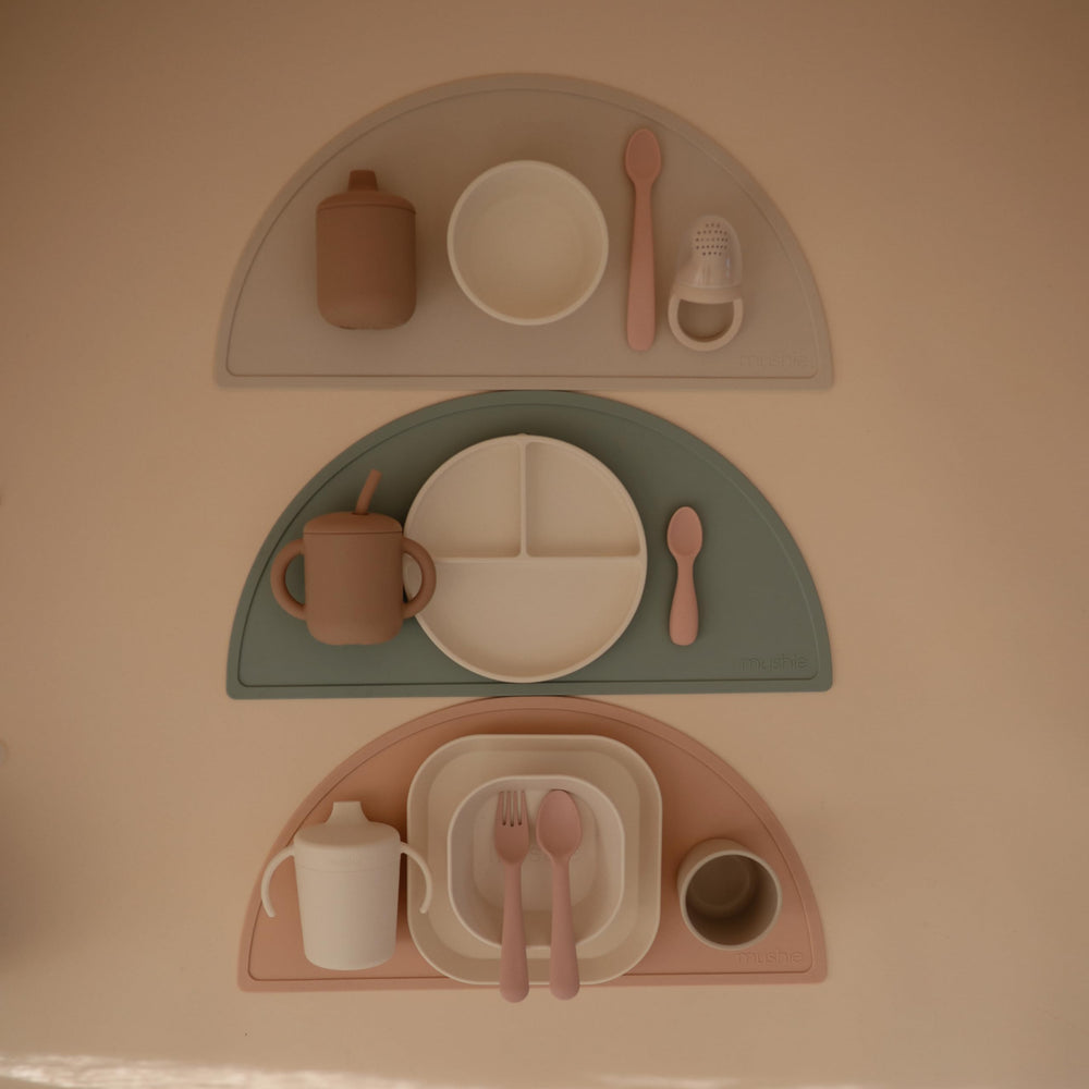 Mushie silicone suction plate ivory baby meal time highlights independent feeding potential.