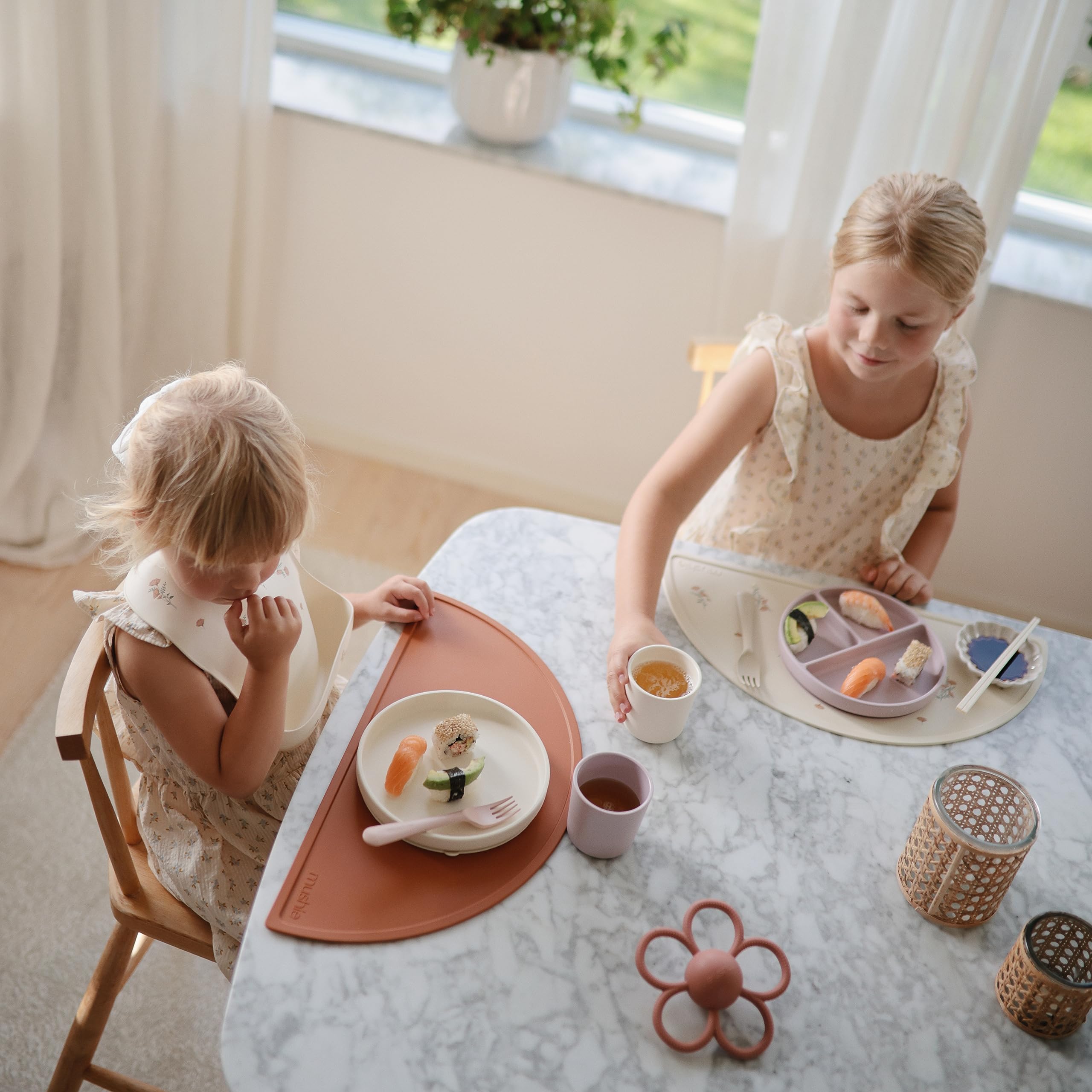 Mushie silicone suction plate ivory food-safe material enables direct heating of small portions.