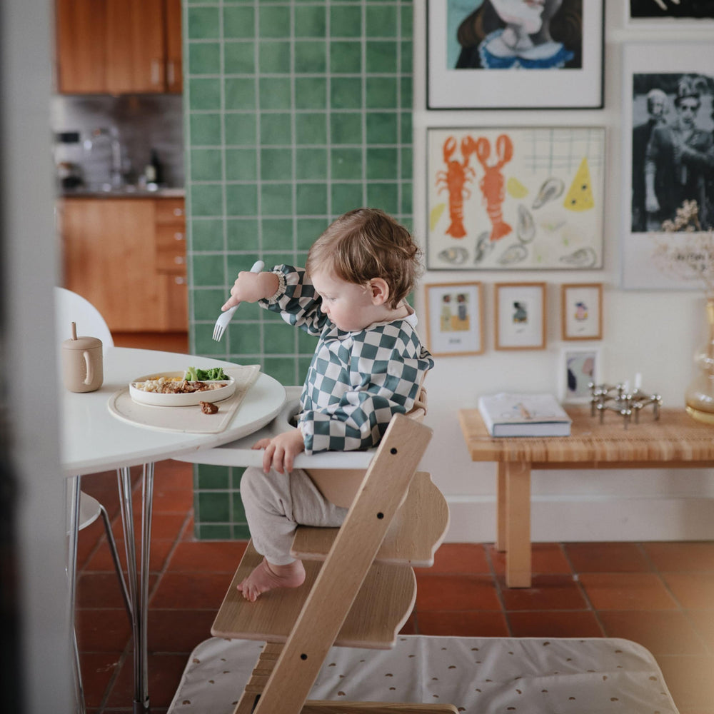 Mushie silicone suction plate ivory served on table illustrates spill-free mealtime.