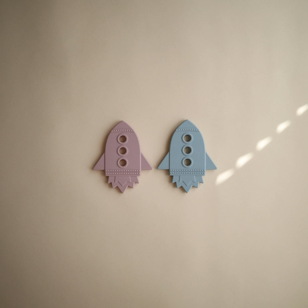 Mushie silicone teether closeup highlights pliable surface for safe chewing.