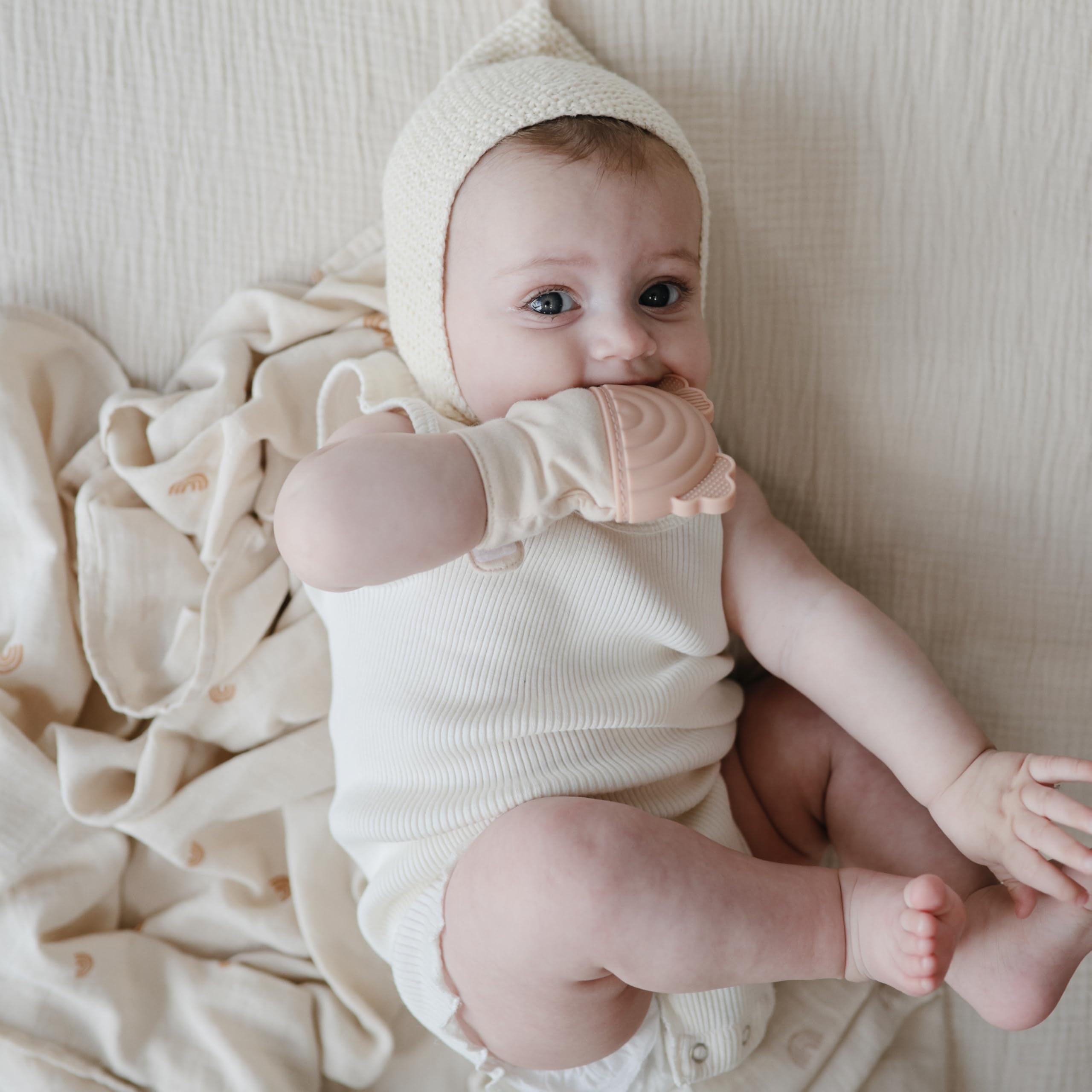 Mushie silicone texture closeup highlights safe biteable surface for teething moments.