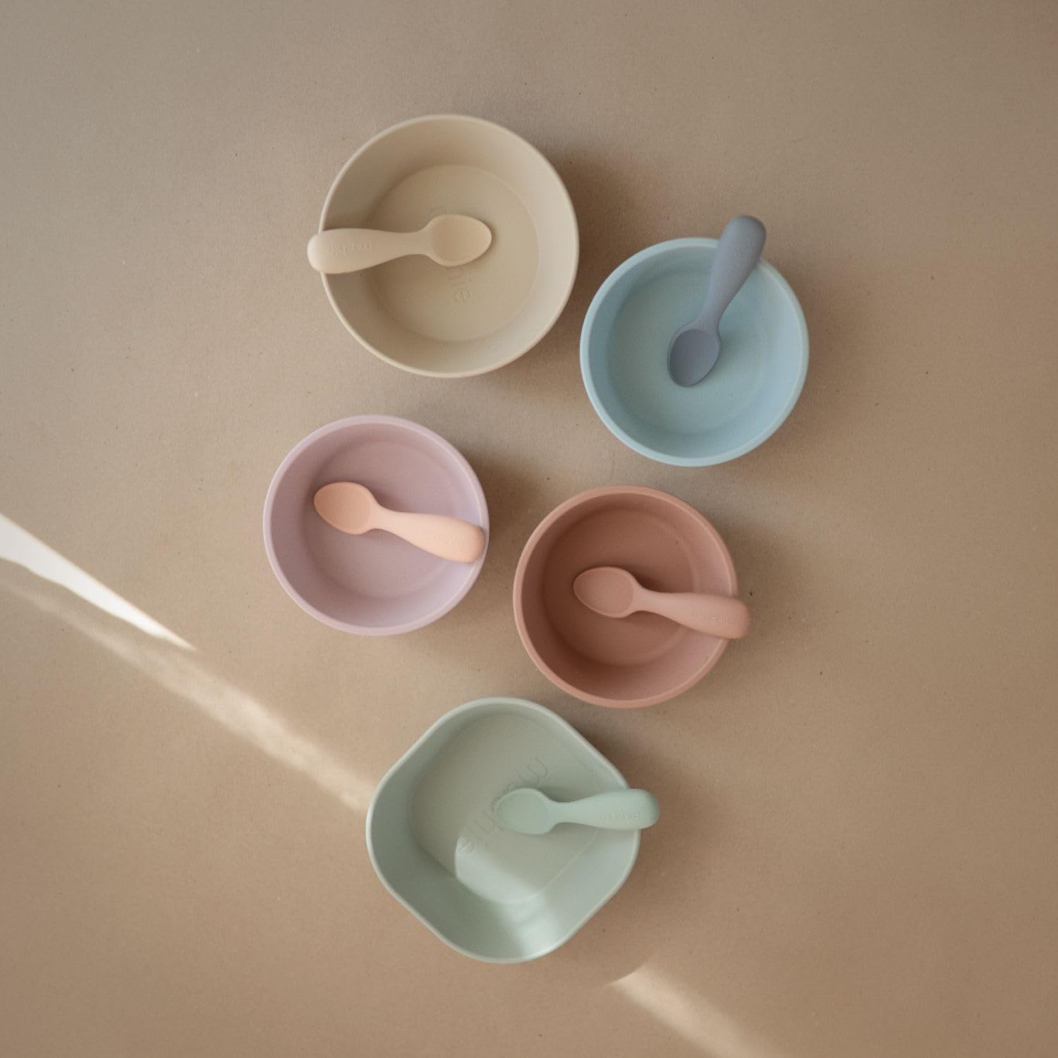 Mushie spoons soft silicone closeup emphasizing gentle touch for tender gums