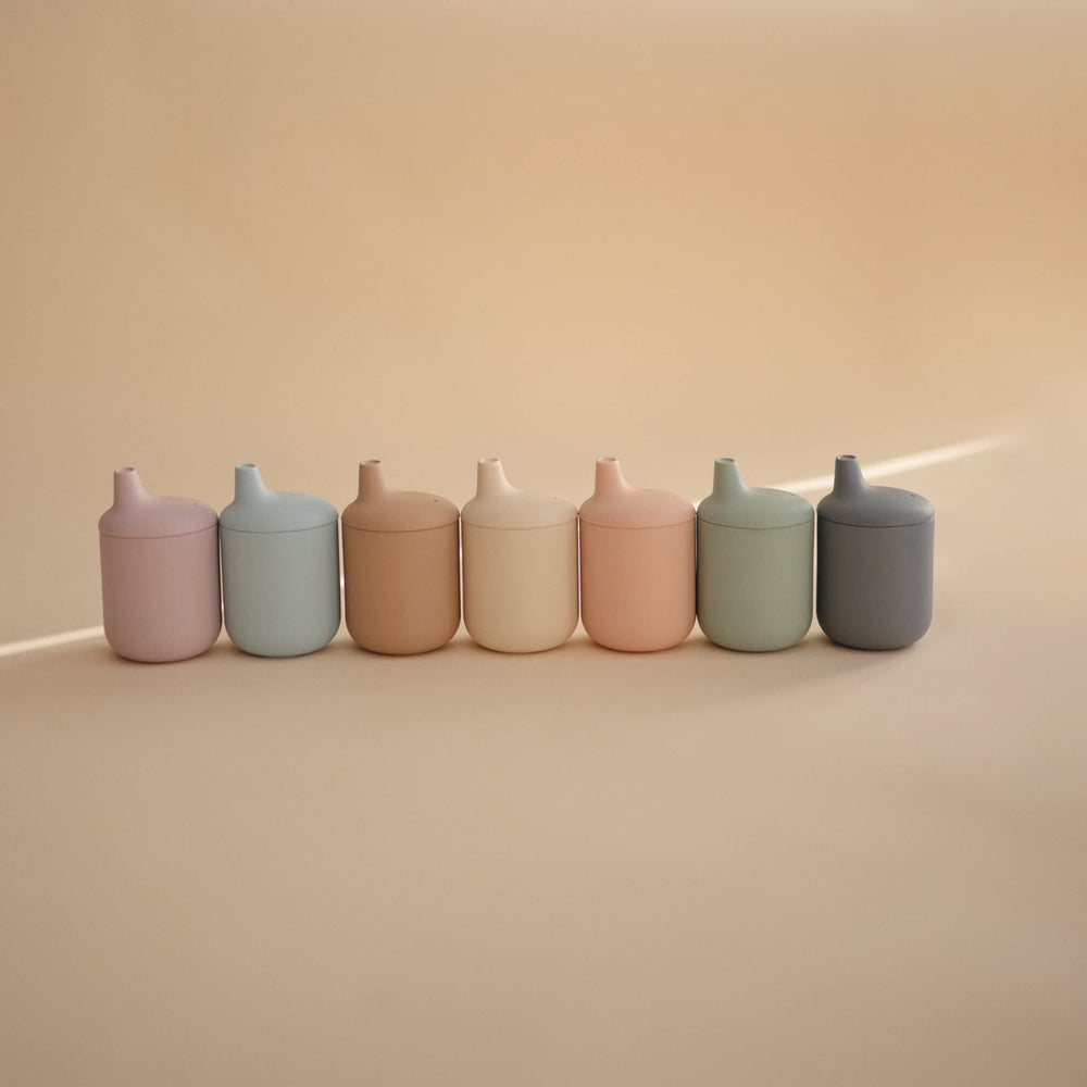 Mushie sippy cup teether-friendly design image suggests soothing during teething