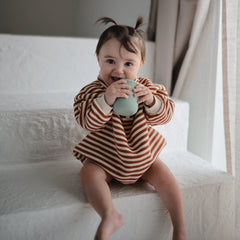 Mushie sippy cup silicone texture provides gentle gums during sipping.