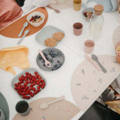 Mushie soft color vanilla flatware on table highlighting calm mealtime aesthetic