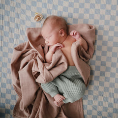Mushie soft muslin crib sheet breathable fabric keeps baby cozy during naps