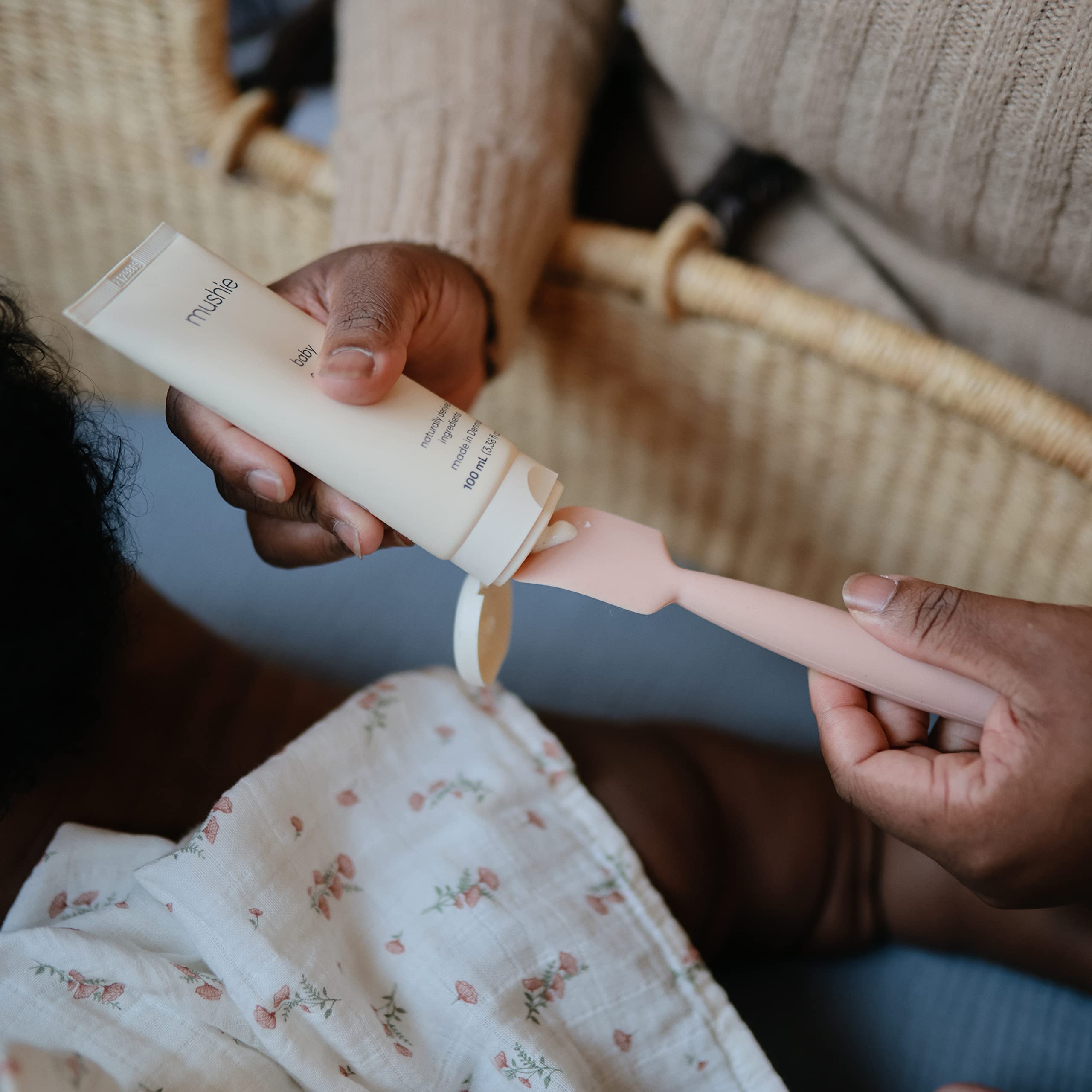 Soft silicone texture of the Mushie applicator shown for comfortable baby care.