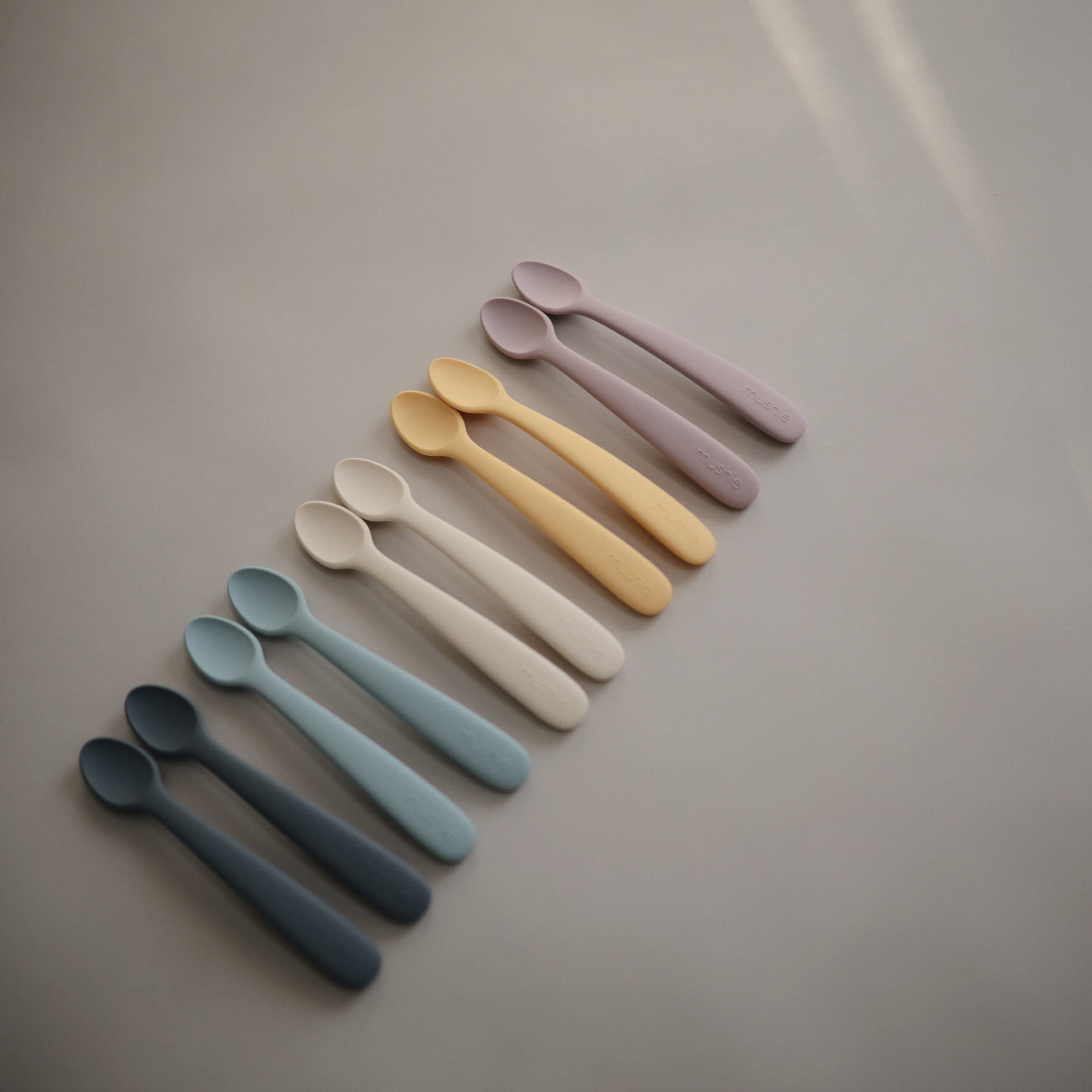 Solid food introduction with Mushie silicone spoon for safe feeding