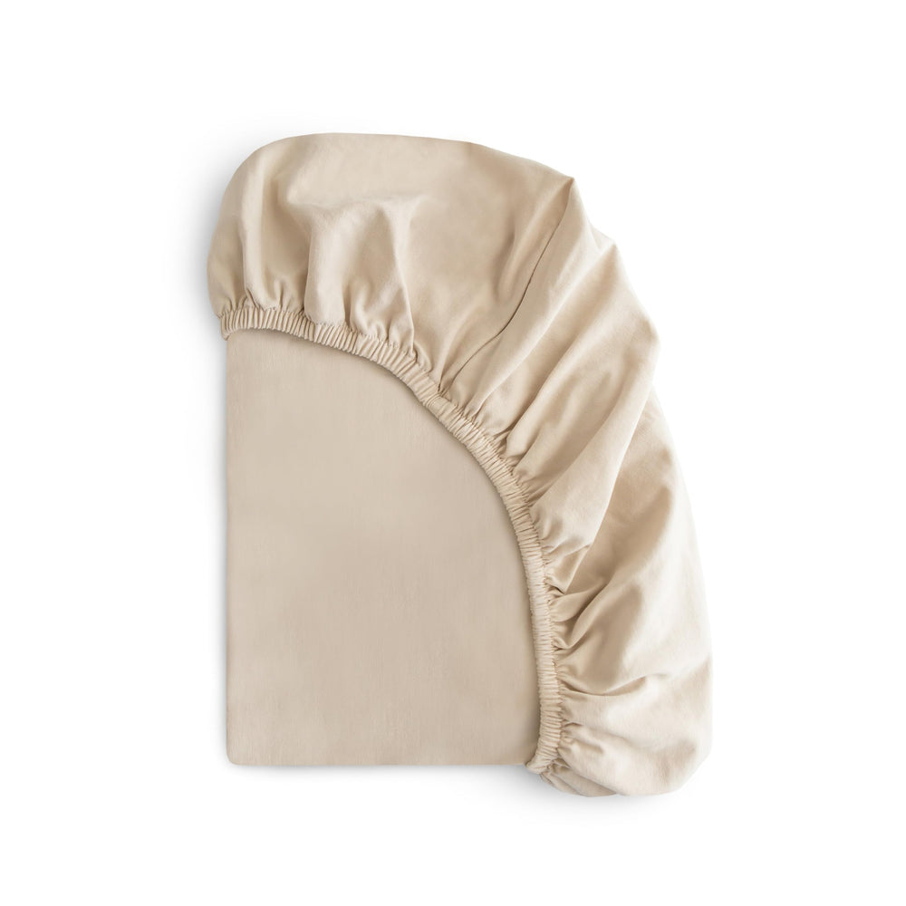 Mushie stretchy mini crib sheet fog folded for easy storage