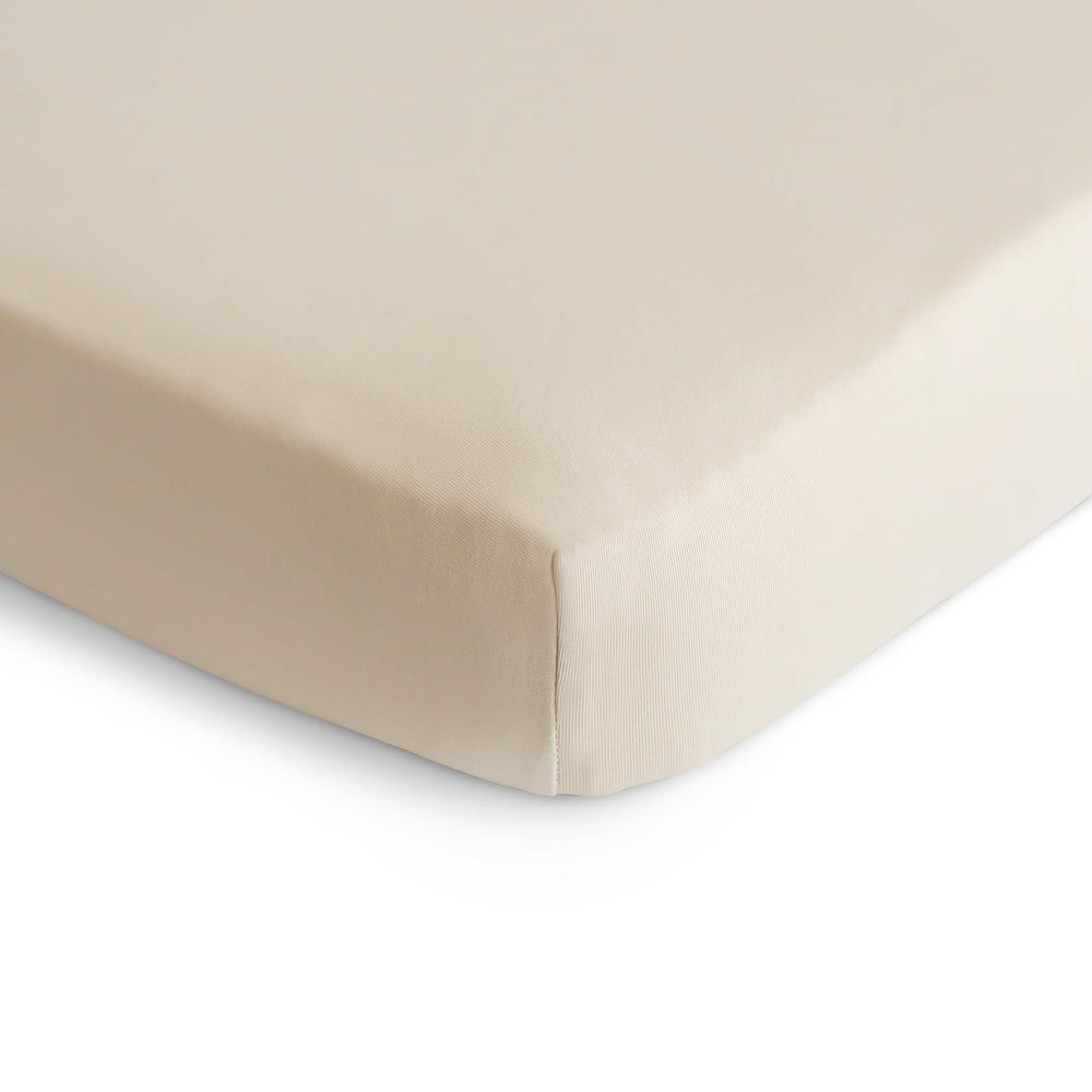 Mushie stretchy mini crib sheet fog on mattress shows snug fit