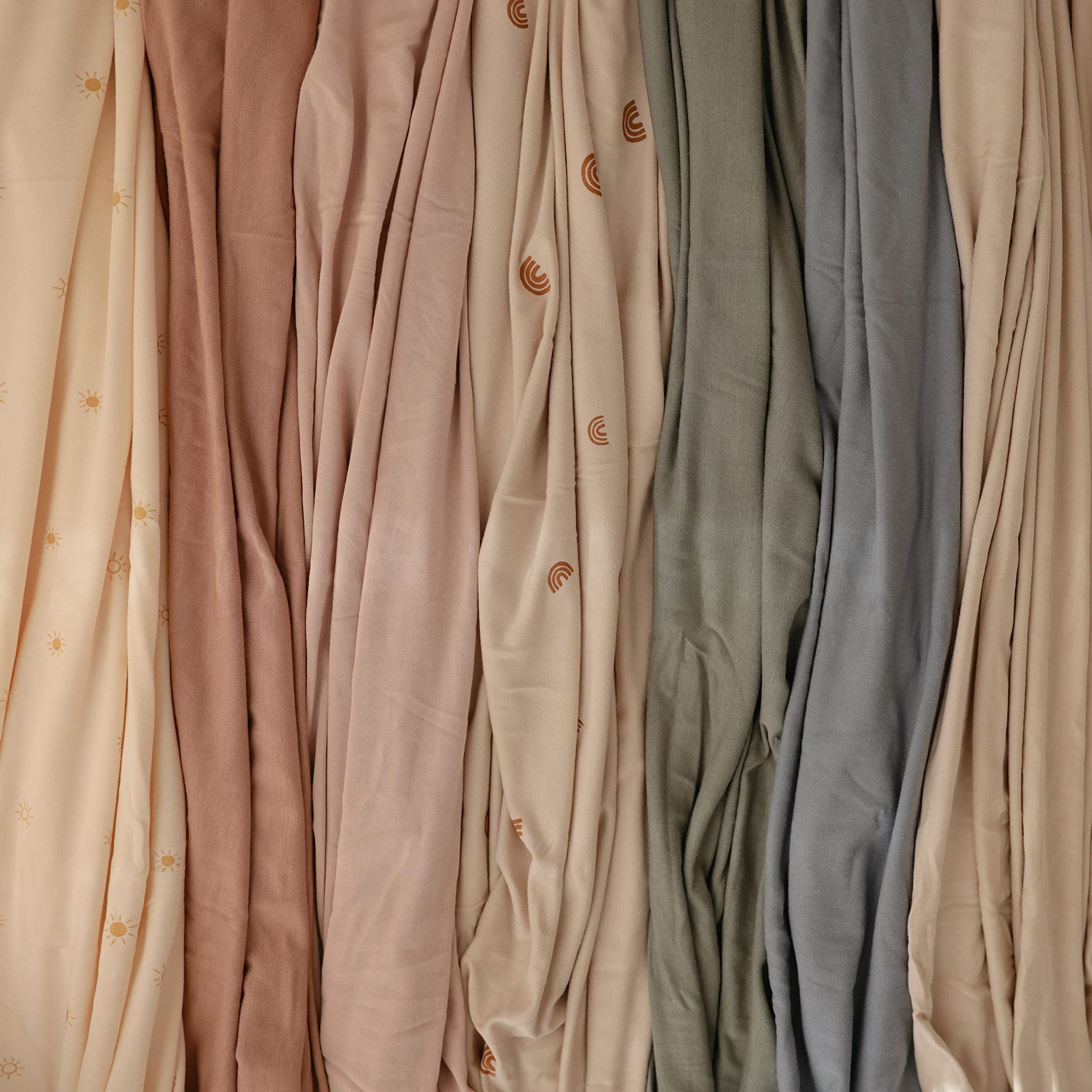 Mushie stretchy swaddle natural closeup shows breathable material for cool comfort.