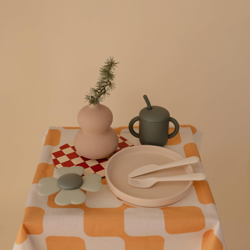 Mushie suction plate on a highchair tray for flexible meals