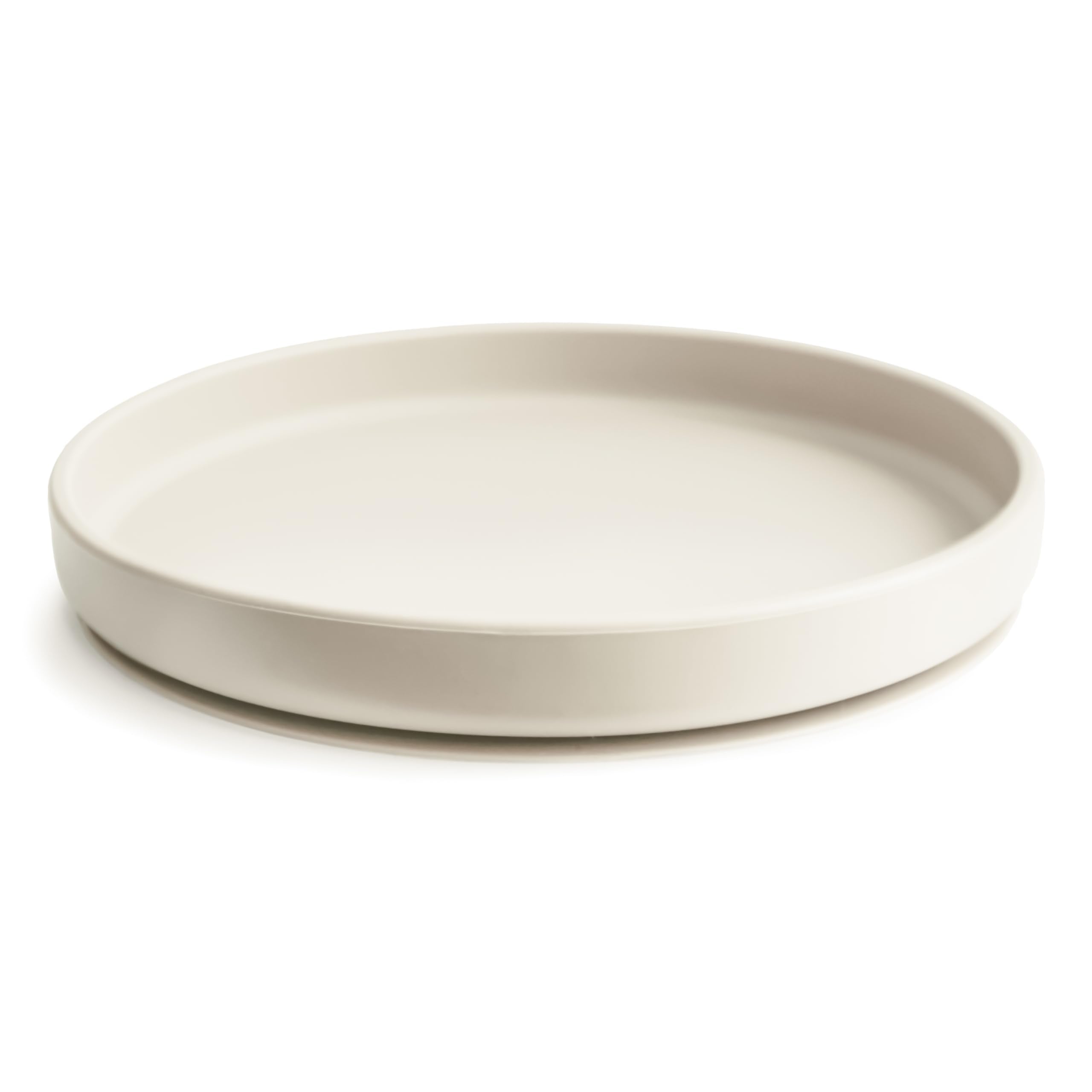 Mushie suction plate on dry surface demonstrates strong suction during feeding.