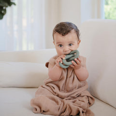 Mushie teether measuring 7.87 x 1.9 inches highlights compact, portable design.