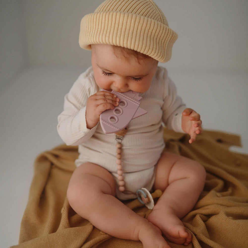 Mushie teether baby hand grip demonstrates easy hold during teething play.