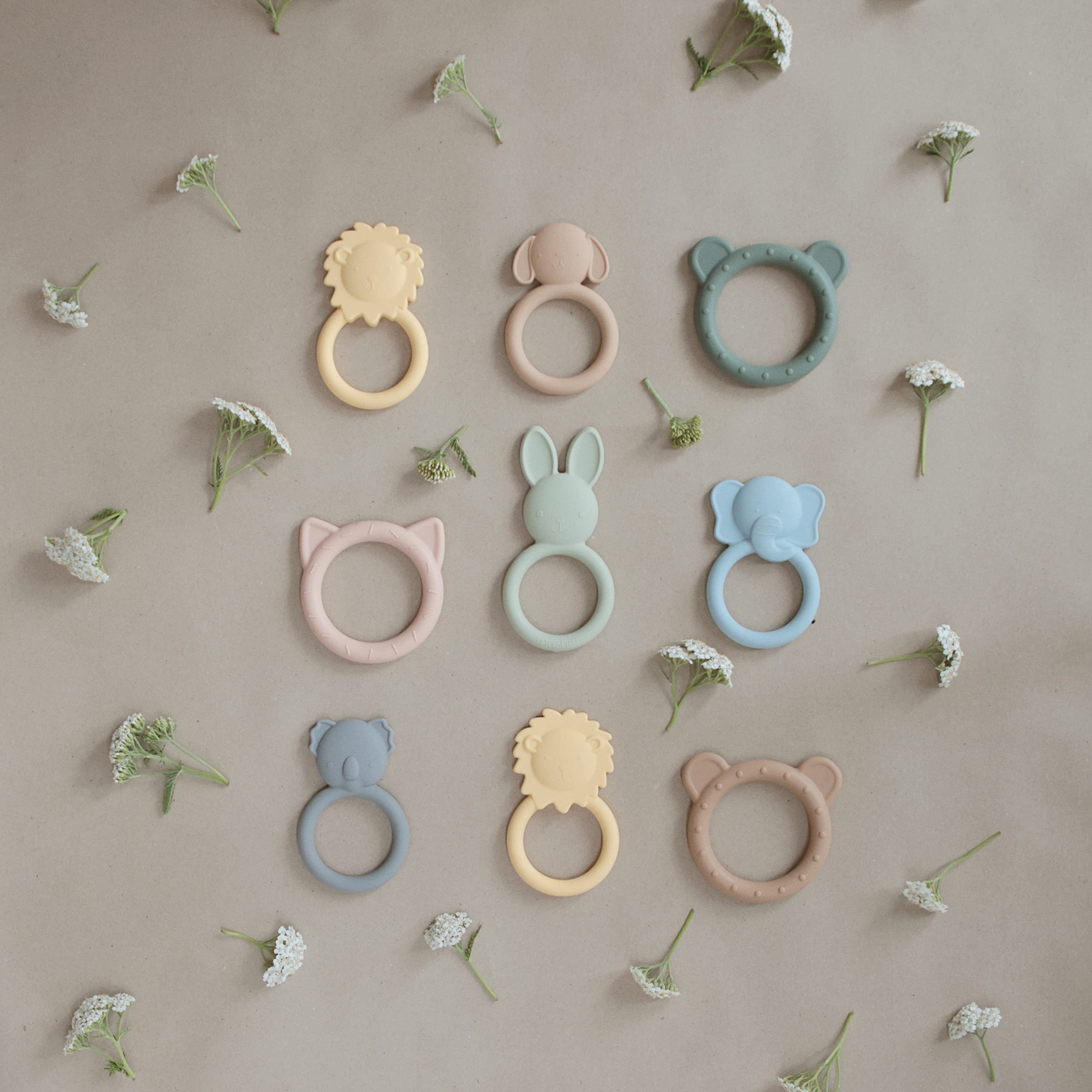 Mushie silicone teether being washed in warm soapy water for easy cleaning
