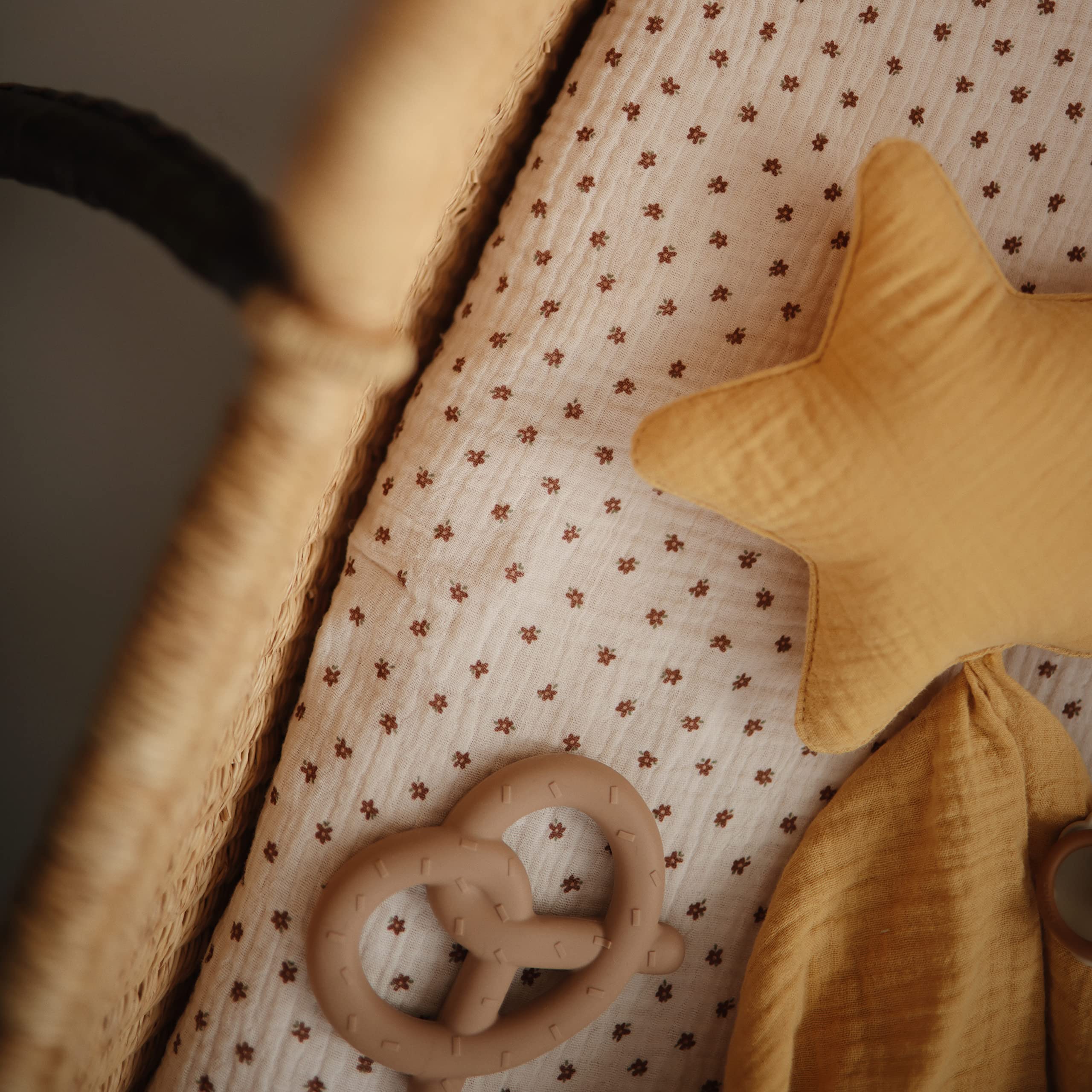 Mushie teether pretzel soothing bite surface shown for calming teething moments.
